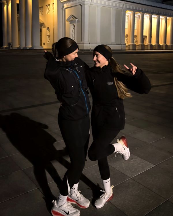 Two Sun United runners at Cathedral Square in the evening